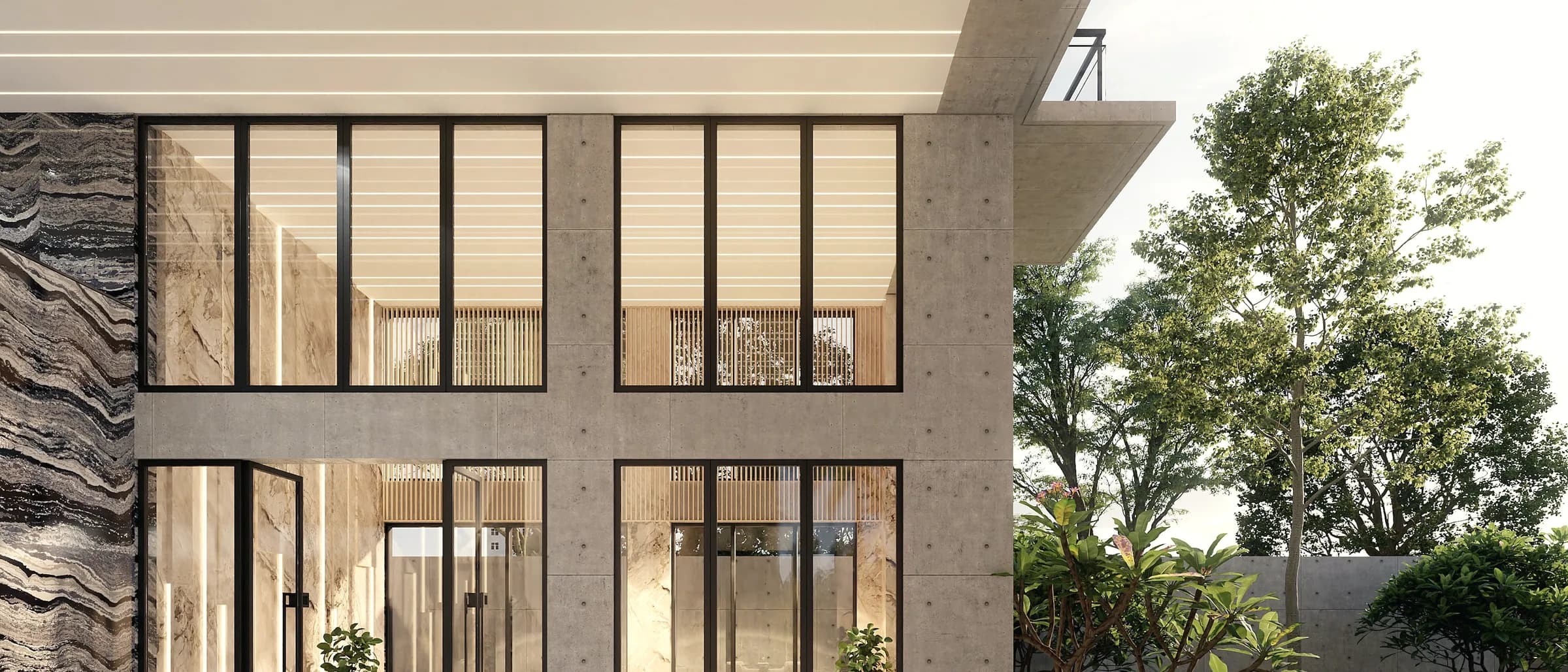 A contemporary house of stone and glass set low into its plot, the upper storey cantilevered over the entrance.