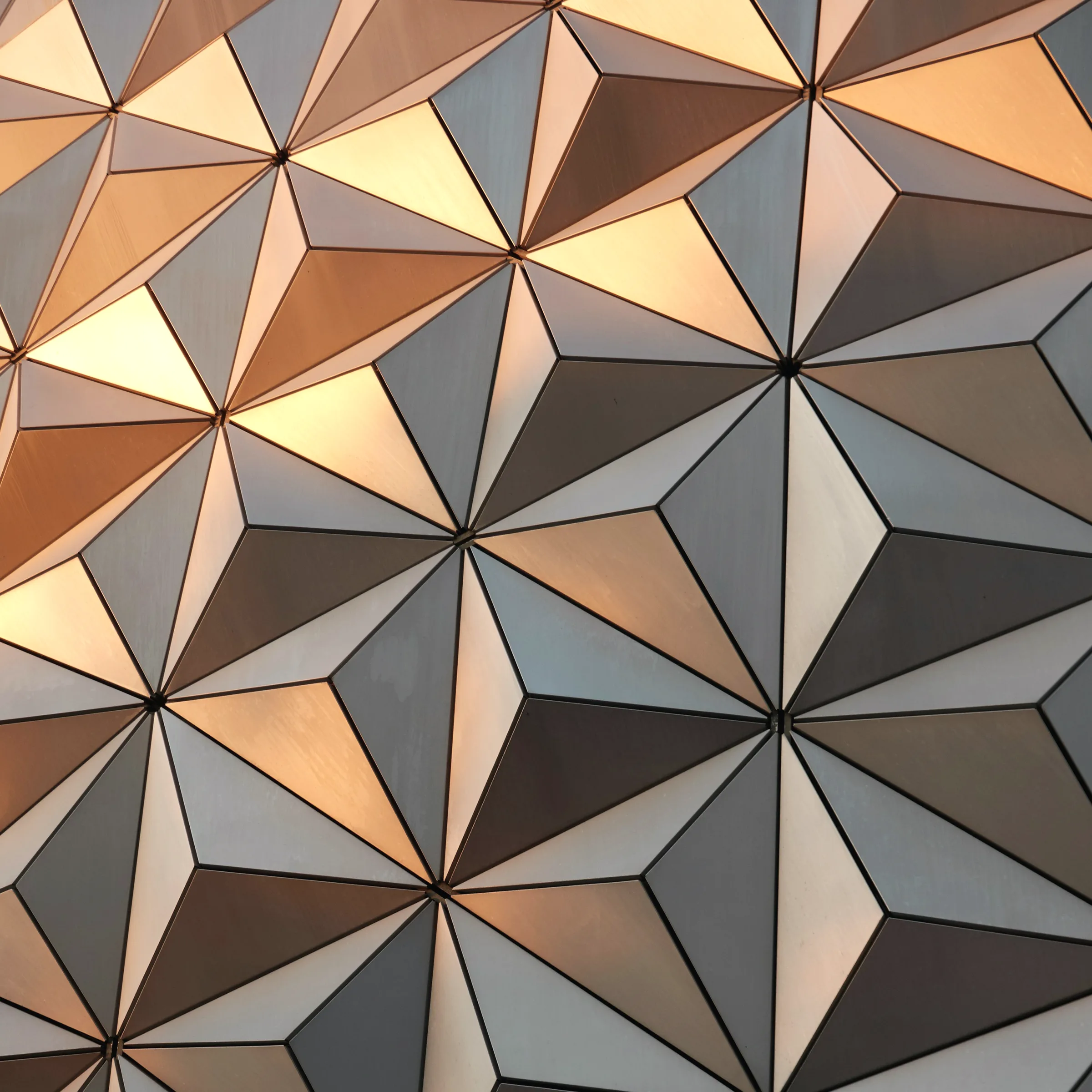 A close view of a patterned facade panel, the relief cut shallow and repeated.