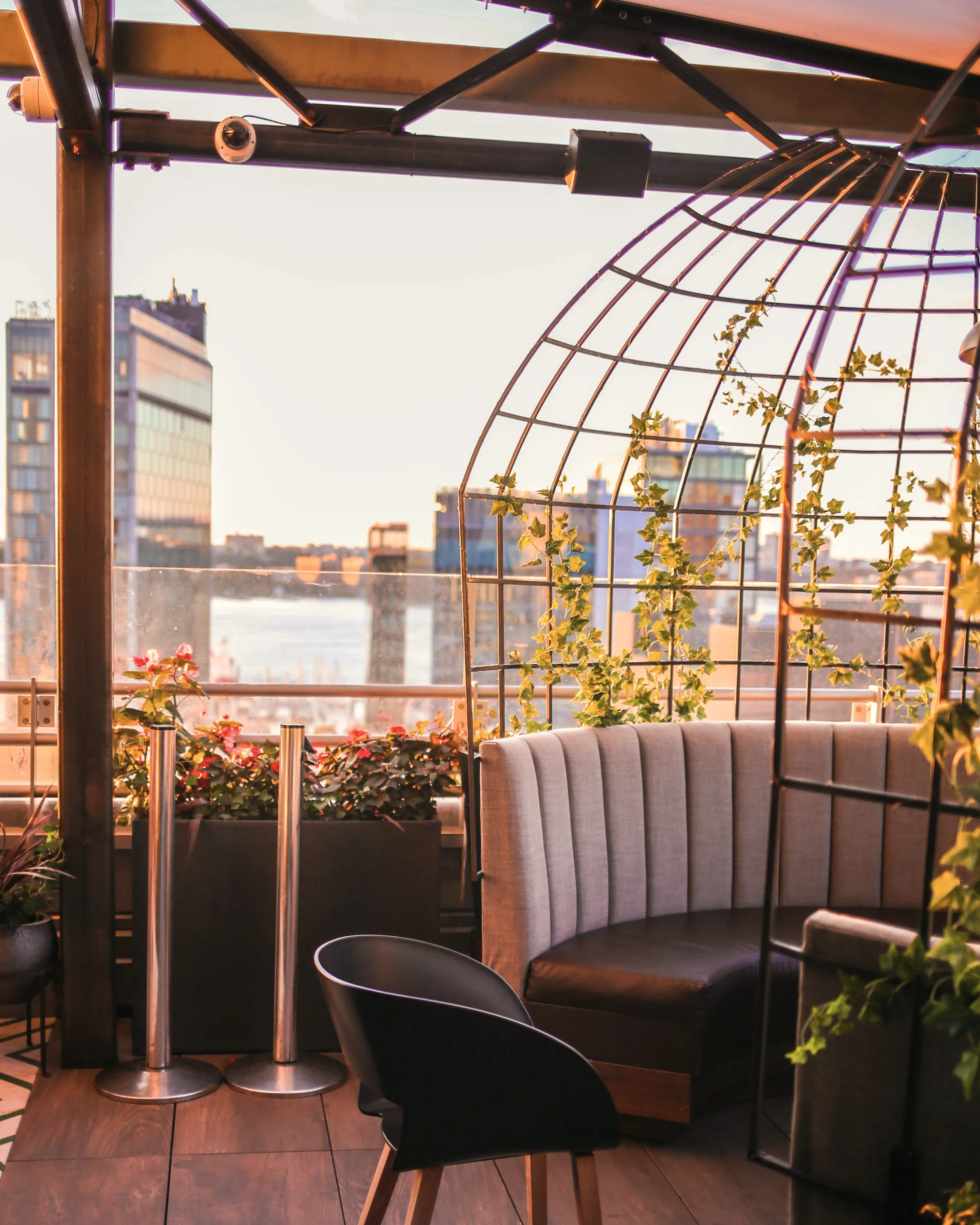 Late sun across a roof terrace above the city.