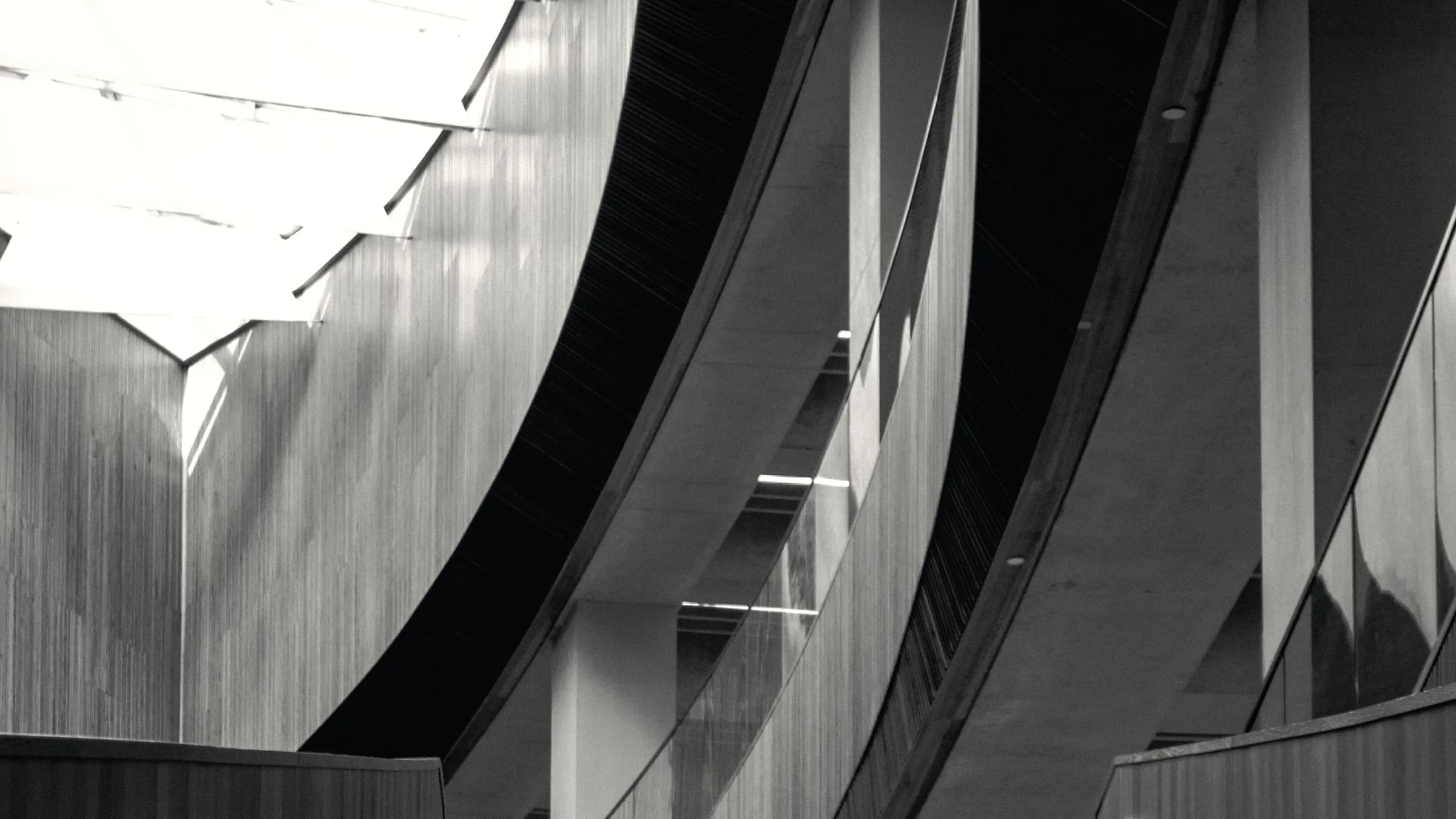 A modern elevation reduced to light and shadow across flat planes.
