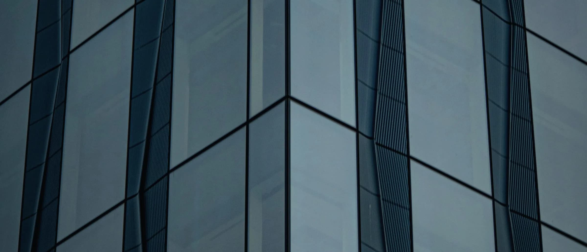 A tall building of pale concrete rising above the surrounding roofline.