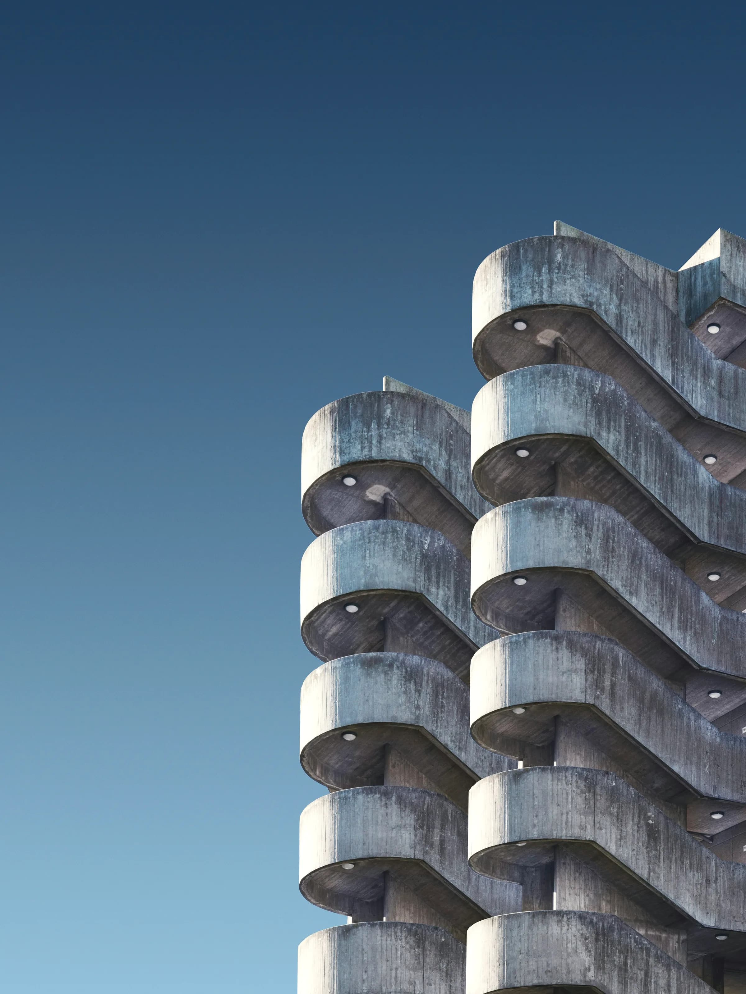 A close view of a residential tower, its floor plates reading as horizontal bands.