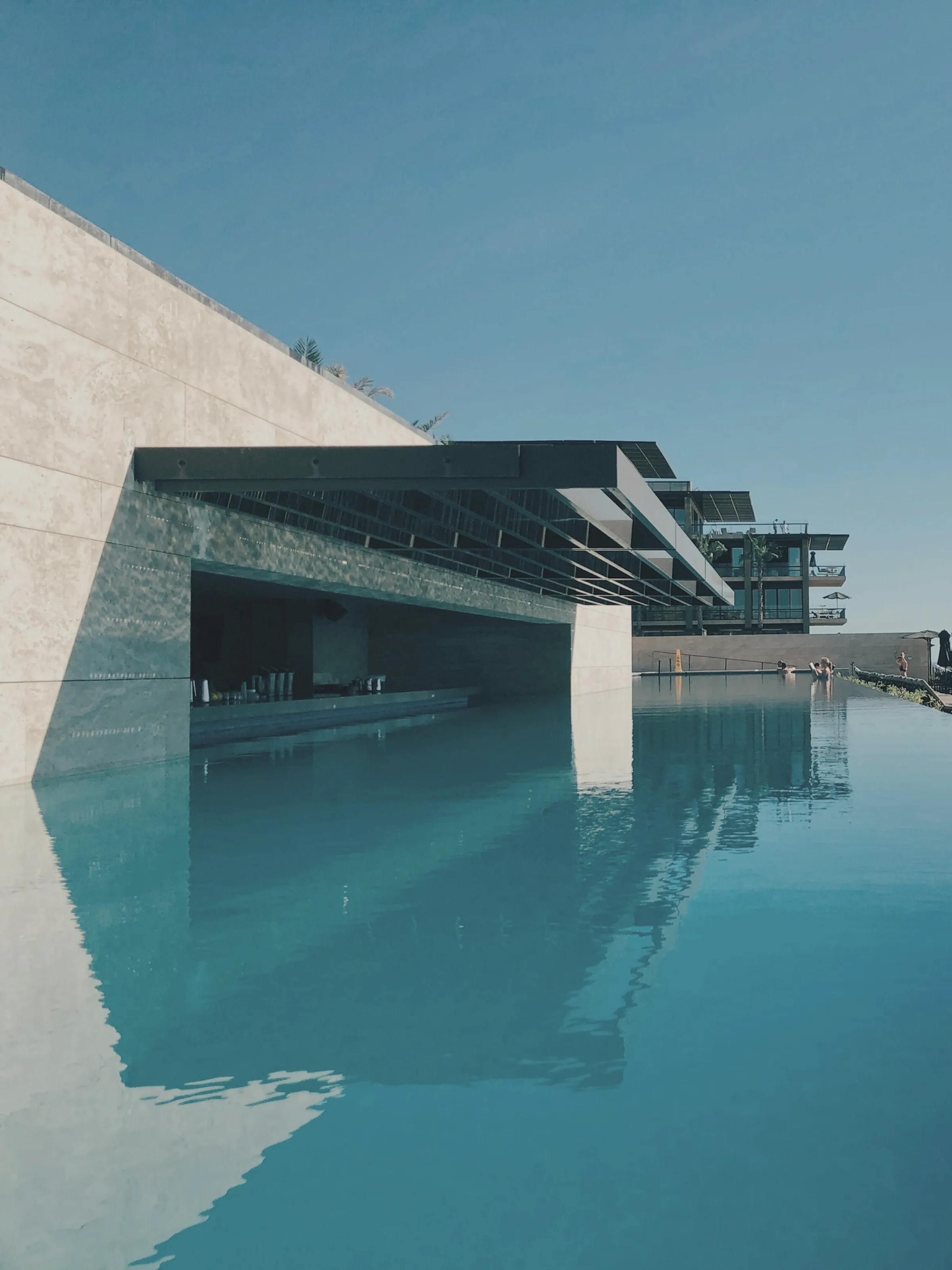 A wide view of a concrete and glass block, its bays reading as one repeated structural unit.