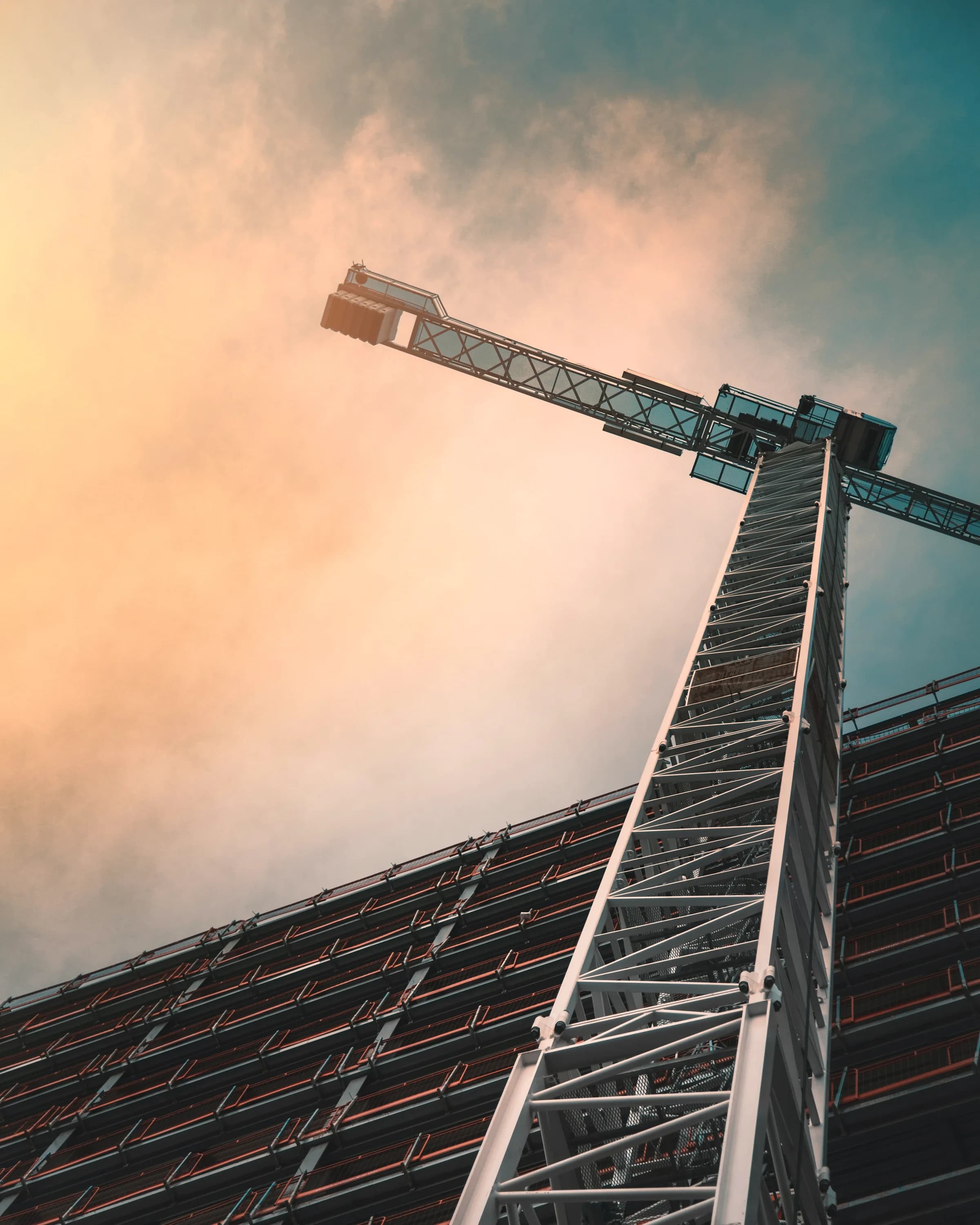 A tower crane standing over a structure still in frame.