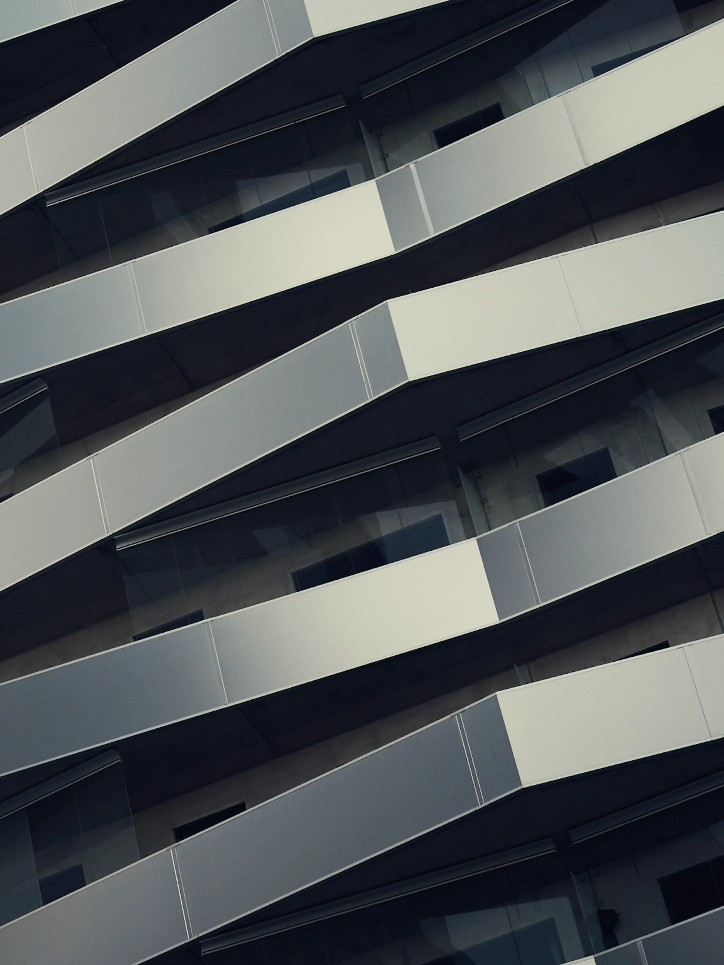 A folded facade whose planes catch light at different angles across the elevation.