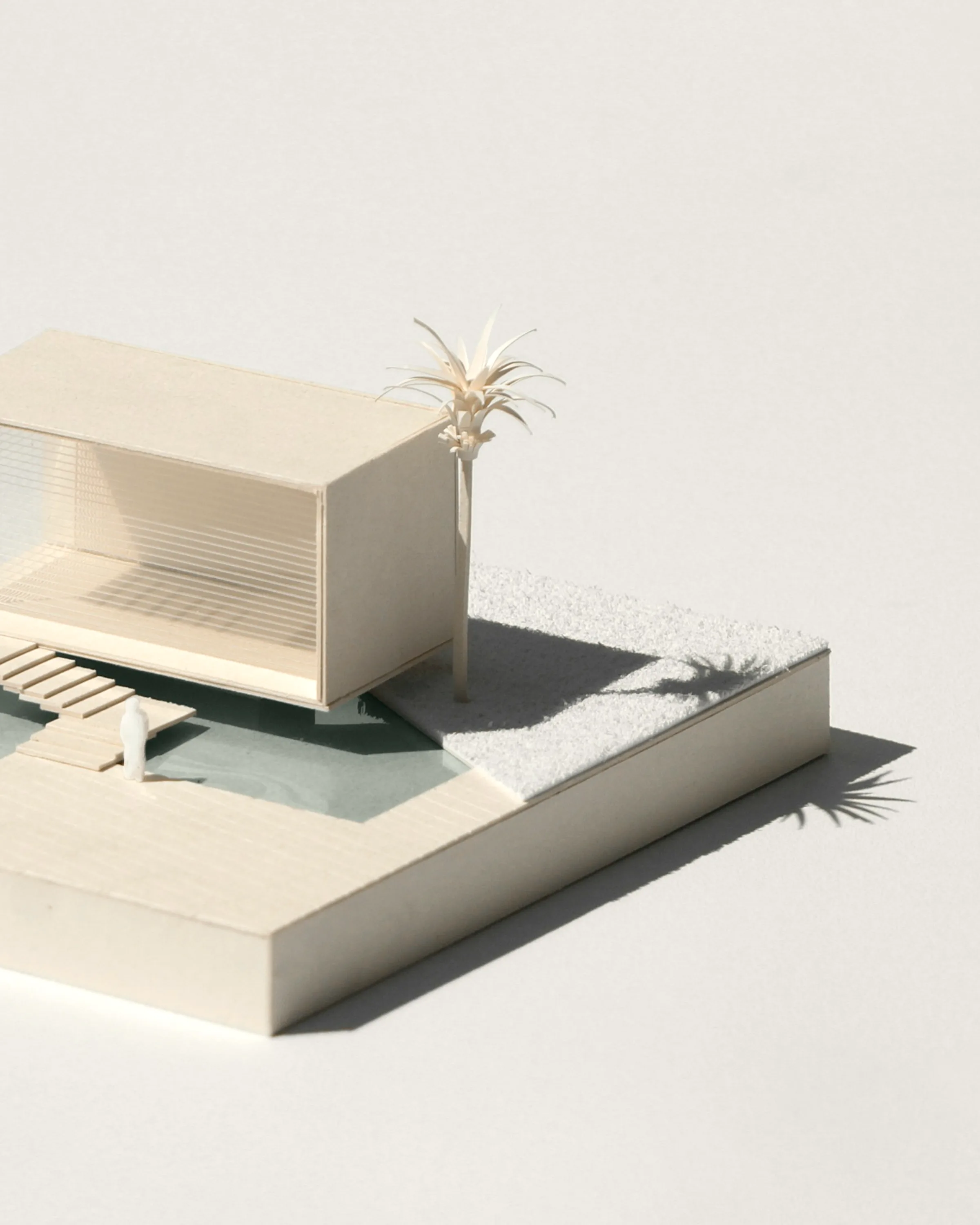 A card massing model of the scheme standing on a plain surface.