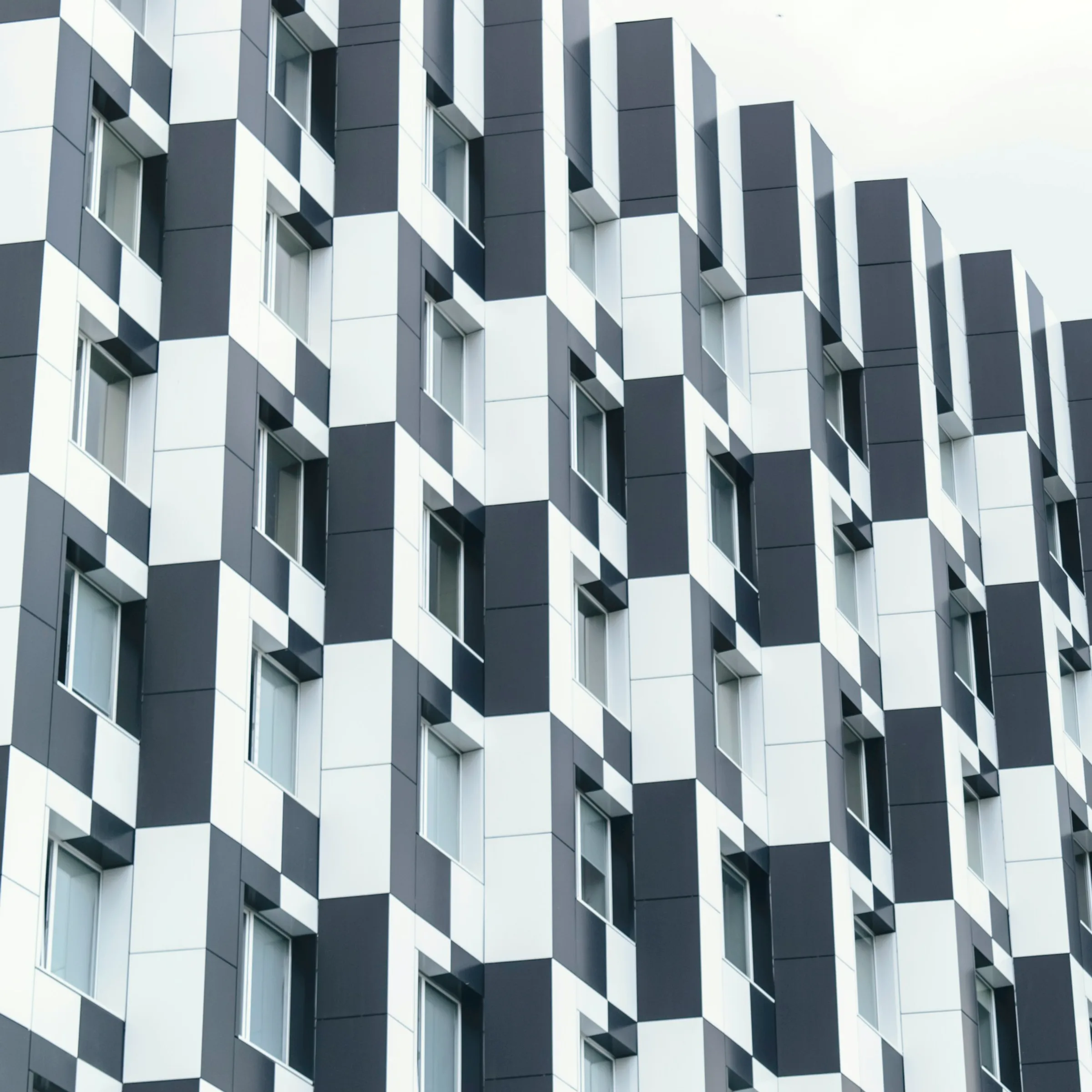 A perforated metal facade reading as a fine grid at distance.