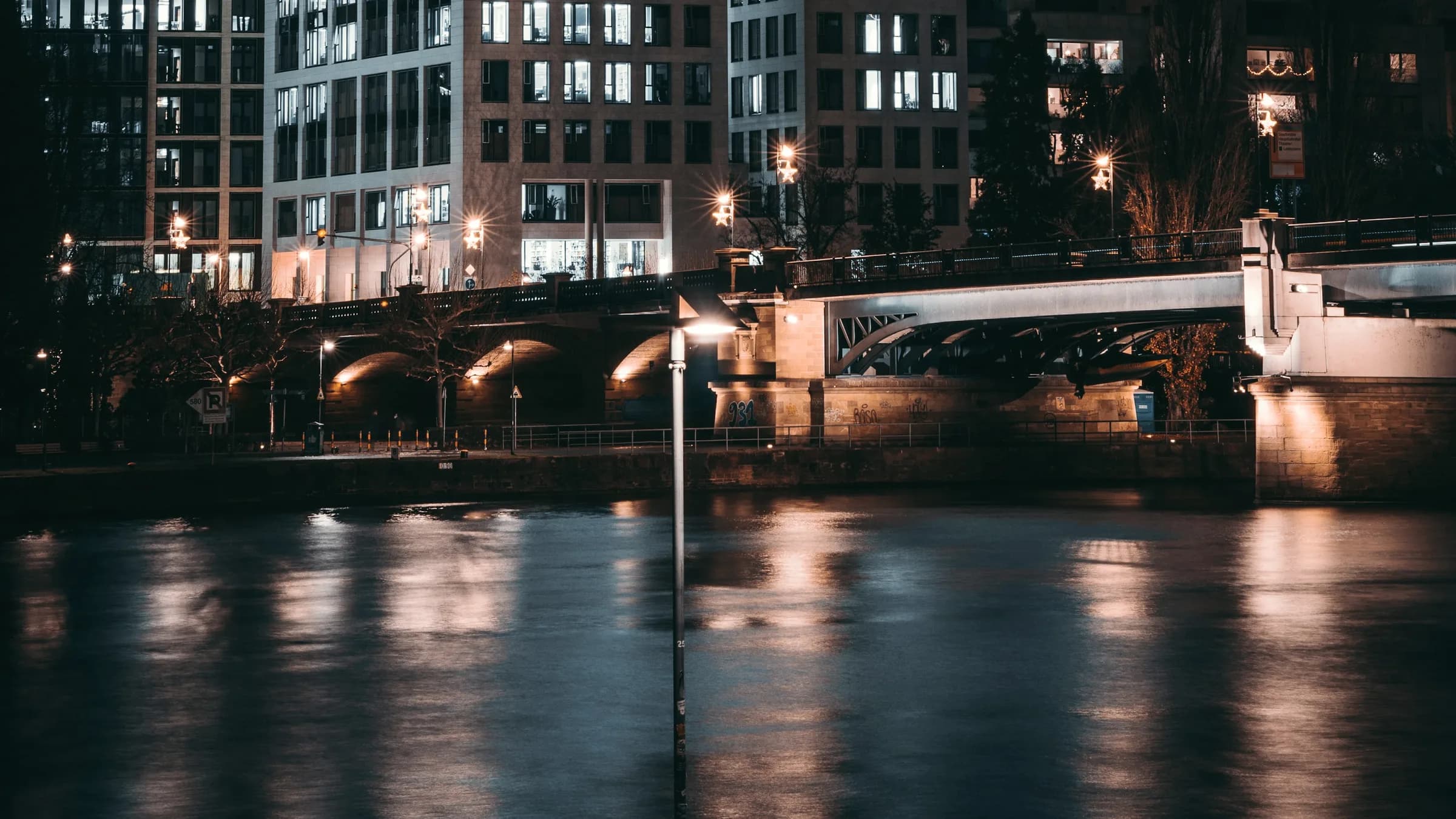 An office building at night, its floors reading only as lit horizontal bands.